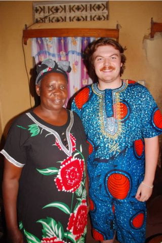 The author next to hist host mother wearing traditional Ugandan clothing