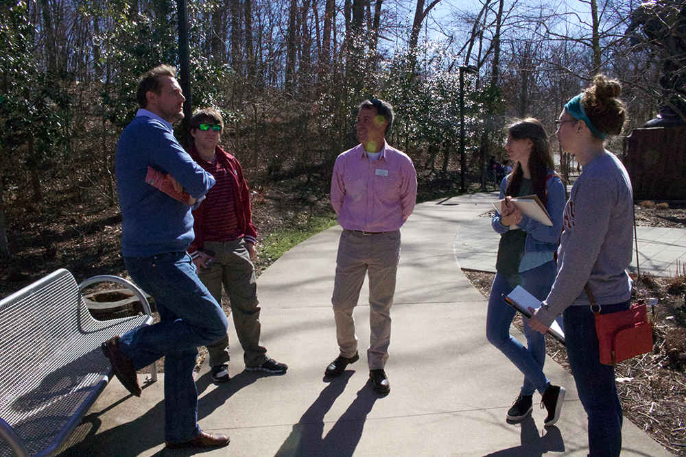 Professor and students on the trail, visit with landscape designer.