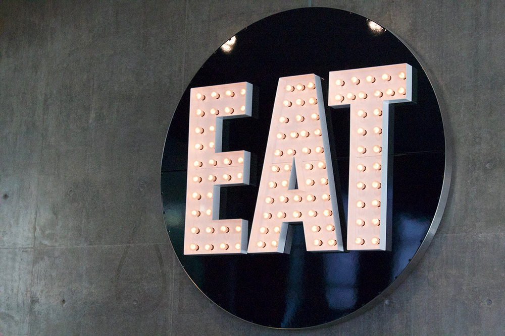 Large sign with EAT lighted up. 