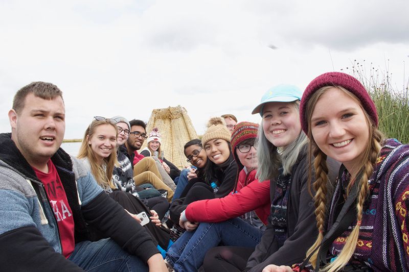 group shot of students on a reed boat.