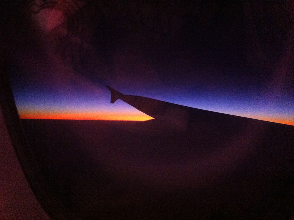 Photo of plane wing taken as sun sets